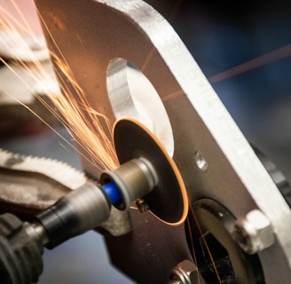 Metal finishing station where deburring smooths out sharp edges on parts.